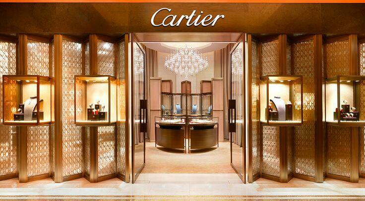 Elegant Cartier luxury boutique in Qatar displaying premium retail environment with gold-accented interior and crystal chandeliers